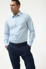 Camisa azul marino con pequeños lunares celestes, de corte clásico y manga larga.