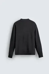 Jersey de punto con textura, corte relajado, cuello redondo y manga larga con acabados en rib.