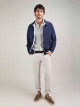 Campera Harrington azul marino con cierre frontal, cuello alto con botones a presión y bolsillos con solapa.
