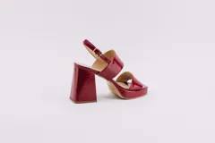 Sandalias de plataforma color crema, con tiras anchas de charol y hebilla ajustable en el tobillo.