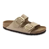 Sandalia Birkenstock modelo Arizona Big Buckle, con dos correas anchas de cuero nobuck en color beige y hebillas grandes metálicas doradas. Cuenta con plantilla anatómica de corcho y suela de goma.