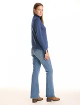 Polera de tejido fino, color rosado, con cuello alto, manga larga y detalle de tajo en los puños.