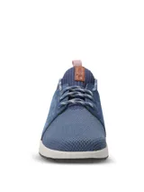 Championes casuales Hush Puppies modelo Spinal Knit, color azul marino. Presentan una combinación de tejido técnico transpirable en la puntera y laterales de cuero gamuzado. Incluyen cordones jaspeados, cuello tejido elástico y suela ergonómica de color blanco con tecnología Spinal para soporte postural.