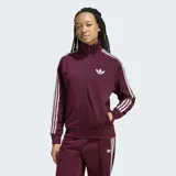 Campera deportiva Adidas modelo Firebird de corte holgado, color bordó con las icónicas tres rayas blancas en las mangas y logo del trébol bordado en el pecho. Cuenta con cierre frontal completo, cuello alto y puños acanalados.