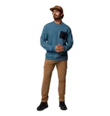 Pantalón cargo color marrón, confeccionado en tejido de algodón elástico. Presenta bolsillos laterales de carga con cierre a presión, bolsillos traseros, bolsillo de seguridad con cremallera y bolsillos para las manos reforzados. Incluye trabillas para cinturón, presilla utilitaria y detalle reflectante en los puños.