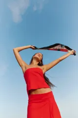 Top strapless rojo confeccionado en lino y rayón, con elástico y lazo para atar en la espalda.