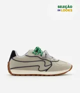 Championes de estilo retro inspirados en botines de fútbol, confeccionados en poliuretano color gris con detalles en azul marino. Presentan cordones en contraste verde y gris, refuerzo en el talón y suela tractorada color caramelo.
