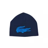 Gorro tipo beanie reversible de Lacoste, confeccionado en tejido de punto. Presenta un diseño azul marino con el logo del cocodrilo en azul brillante en el frente.