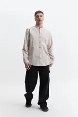 Camisa de hombre color gris con cuello mao, mangas largas y cierre abotonado. Confeccionada en algodón con look lino.