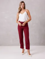 Pantalón sastrero slim negro de tiro alto, con pretina anatómica, pinzas verticales frontales y cierre oculto. Tiene bolsillos laterales inclinados y pinzas traseras para un ajuste favorecedor.