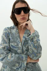 Blazer de jean con estampado paisley en tonos azules y tostados, solapas clásicas y mangas largas.