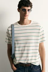 Camiseta de corte regular fit color crudo con diseño de rayas horizontales finas en tonos marrón y azul, cuello redondo y manga corta.