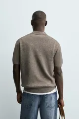 Polo de punto de algodón con corte regular, cuello solapa y cierre frontal de cremallera. Presenta manga corta y acabados en rib.