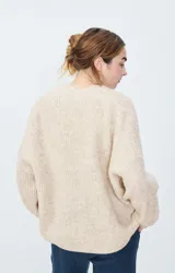 Cárdigan corto de punto color negro, con mangas largas y corte holgado.