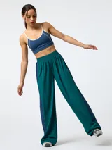 Pantalón ancho de microfibra, de corte holgado estilo retro vintage, en color verde oscuro con franjas laterales en contraste de color azul.