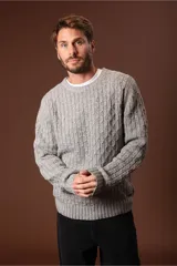 Sweater de punto color gris claro, con cuello redondo y diseño de tejido trenzado.