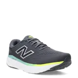 Championes New Balance Evoz Fresh Foam para hombre, color gris oscuro con detalles en verde lima y celeste en la entresuela. Presentan el logo 'N' plateado en el lateral y tecnología Fresh Foam.