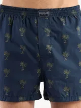 Bóxer de algodón blanco con estampado de flores pequeñas color celeste, con cintura elástica y logo de la marca en el centro.