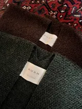 Ruana marrón de tejido de punto grueso, confeccionada en 100% baby alpaca.