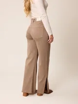 Pantalón jean de tiro alto y corte recto, color marrón chocolate, con aberturas laterales en el ruedo.