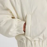 Campera bomber acolchada de color blanco, con cierre frontal de cremallera, cuello alto, mangas raglán y cintura elástica. Presenta bolsillos laterales ribeteados y el logotipo de la marca bordado en tono sobre tono en el pecho.