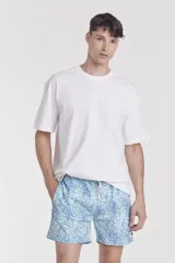 Short de baño azul con estampado de naranjas y hojas verdes.