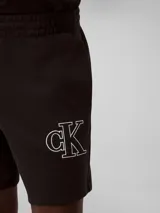 Short negro de punto de algodón acanalado con cintura elástica, bolsillos laterales y trasero. Presenta un monograma de CK bordado en blanco en la parte delantera.