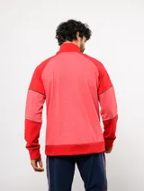 Buzo deportivo de medio cierre marca Umbro del Club Nacional de Football. Presenta un diseño en tonos azul y gris jaspeado, con cuello alto, mangas largas y detalles de costuras en contraste. Incluye el escudo del club y logo de la marca en el pecho.
