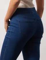 Jegging de denim azul oscuro con cintura elástica, bolsillos delanteros simulados y bolsillos traseros funcionales.