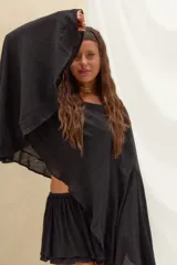 Set de blusa estilo capa de corte holgado con mangas amplias y short con volados y cordón ajustable en la cintura, confeccionado en lino color negro.