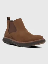 Bota tipo Chelsea de cuero color marrón, con paneles elásticos laterales y suela tecnológica Spinal Flex de color marrón oscuro que ofrece amortiguación y soporte.