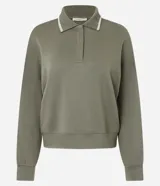 Buzo cerrado de algodón con cuello polo, mangas largas con puños ajustados y detalle de líneas contrastantes en el cuello.