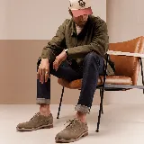 Zapato de vestir tipo oxford confeccionado en cuero vacuno color tostado, con detalles de perforaciones decorativas en el talón y suela de goma con taco bajo.