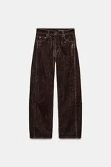 Jeans de tiro alto con corte balloon leg y largo completo. Presentan diseño de cinco bolsillos, trabillas en la cintura y cierre frontal con cremallera y botón. Confeccionados en tejido flocado con textura aterciopelada.