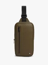 Cartera tipo sling Tommy Hilfiger de color verde militar, con diseño de monograma TH en relieve, bolsillo exterior con cierre y correa ajustable negra.
