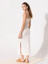 Vestido largo color crudo de punto liso, con breteles finos y escote recto.