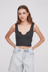 Musculosa corta gris oscuro de algodón con escote en U y terminación ondulada en el ruedo.