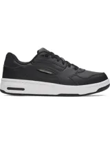 Championes Under Armour modelo Flex, color negro con suela blanca. Presentan un diseño urbano con empeine de cuero premium, panel de talón acanalado y entresuela de EVA para mayor amortiguación.