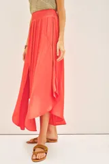 Falda midi de corte fluido con cintura elástica fruncida, confeccionada en tejido satinado de color coral.