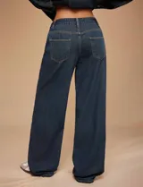 Jean de tiro medio con calce wide leg y pierna amplia, confeccionado en denim rígido de color azul oscuro.