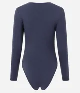 Body de manga larga con cuello redondo, confeccionado en tejido de poliamida y elastano sin costuras. Presenta un diseño ajustado al cuerpo con cierre inferior mediante botones de presión.