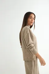 Conjunto de dos piezas compuesto por un sweater de cuello alto con aberturas laterales en el ruedo y un pantalón de corte recto y holgado, ambos confeccionados en tejido de punto suave.