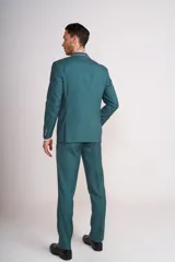 Ambo de ceremonia color verde petróleo, compuesto por saco de dos botones, pantalón de corte recto y chaleco gris con estampado jacquard. Incluye pañuelo de bolsillo y corbatón a juego.