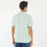 Chomba de piqué de algodón color verde claro, corte clásico, con cuello polo y tapeta de dos botones.