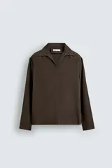 Camisa de manga larga color marrón oscuro, con cuello solapa y abertura frontal, confeccionada en tejido fluido con mezcla de modal. Presenta un calce relajado y aberturas laterales en el bajo.