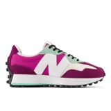 Championes New Balance modelo 327, de dama, con diseño multicolor en fucsia, morado, blanco, verde menta y negro. Presentan una entresuela ensanchada, empeine de ante y malla, y una marca "N" de gran tamaño aplicada asimétricamente. La suela tiene un relieve inspirado en el trail.
