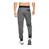 Pantalón de jogging Under Armour, color gris jaspeado, con cintura elástica ajustable con cordón, puños en los tobillos y bolsillos laterales con cierre. Presenta el logo de la marca estampado en la pierna derecha.