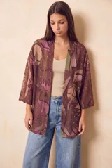 Kimono de viscosa con estampado abstracto en tonos marrones, violetas y verdes, con detalles de hilos dorados y mangas tres cuartos.