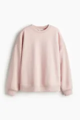 Buzo de tejido de punto color rosa pálido, con cuello redondo, hombros caídos y puños y bajo acanalados.