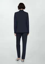 Blazer de corte entallado y diseño recto, con solapas con muesca, hombros estructurados y cierre frontal de un botón. Cuenta con dos bolsillos de ribete delanteros, abertura posterior y forro interior.